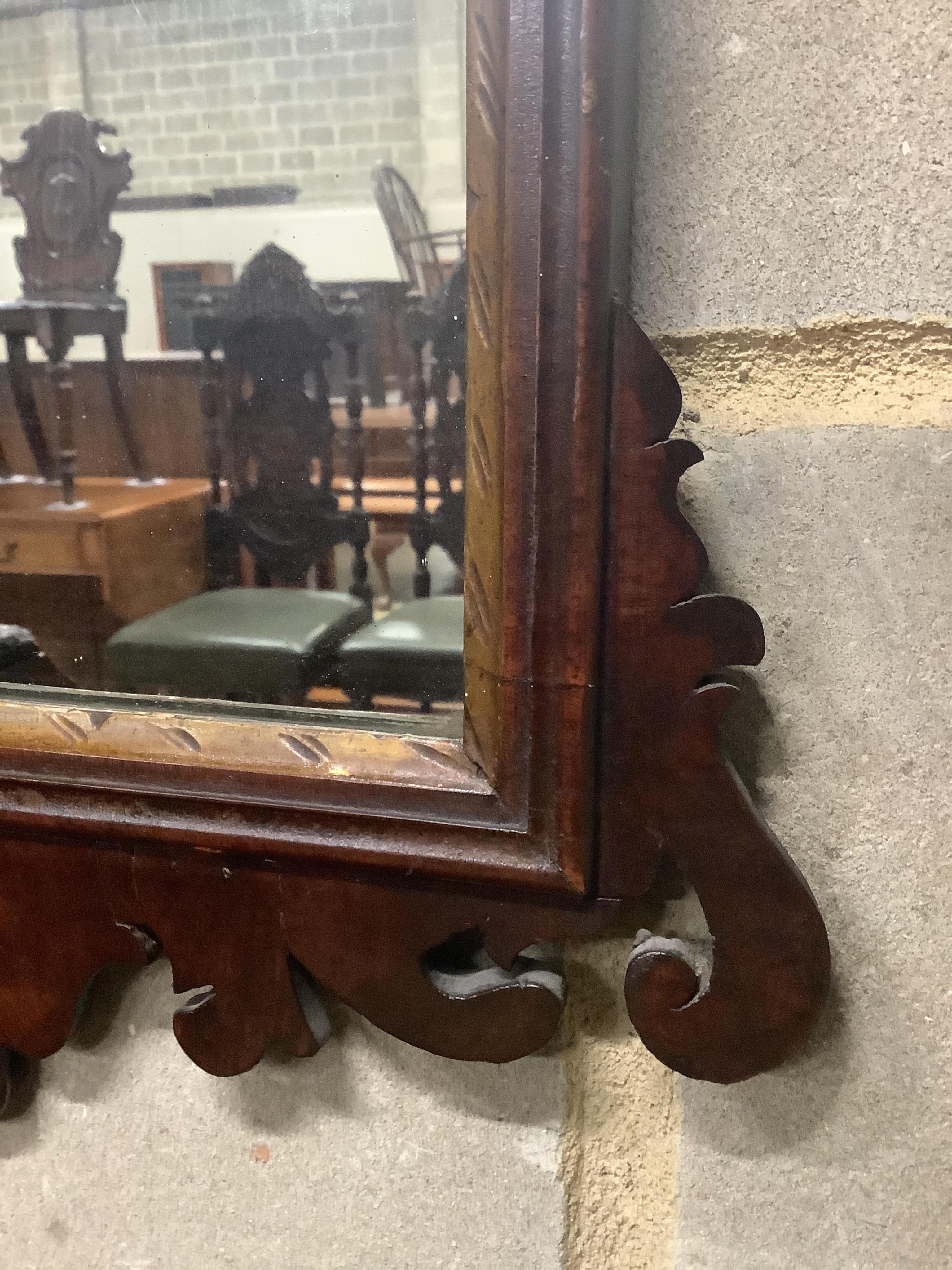 An early 19th century mahogany fret cut wall mirror, width 38cm, height 64cm. Condition - fair